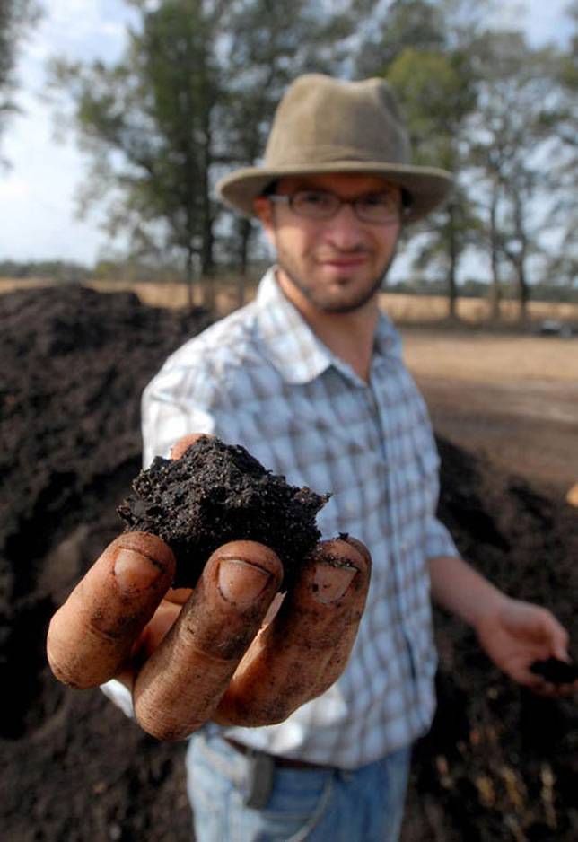 Daron Joffe holds up a piece of compost