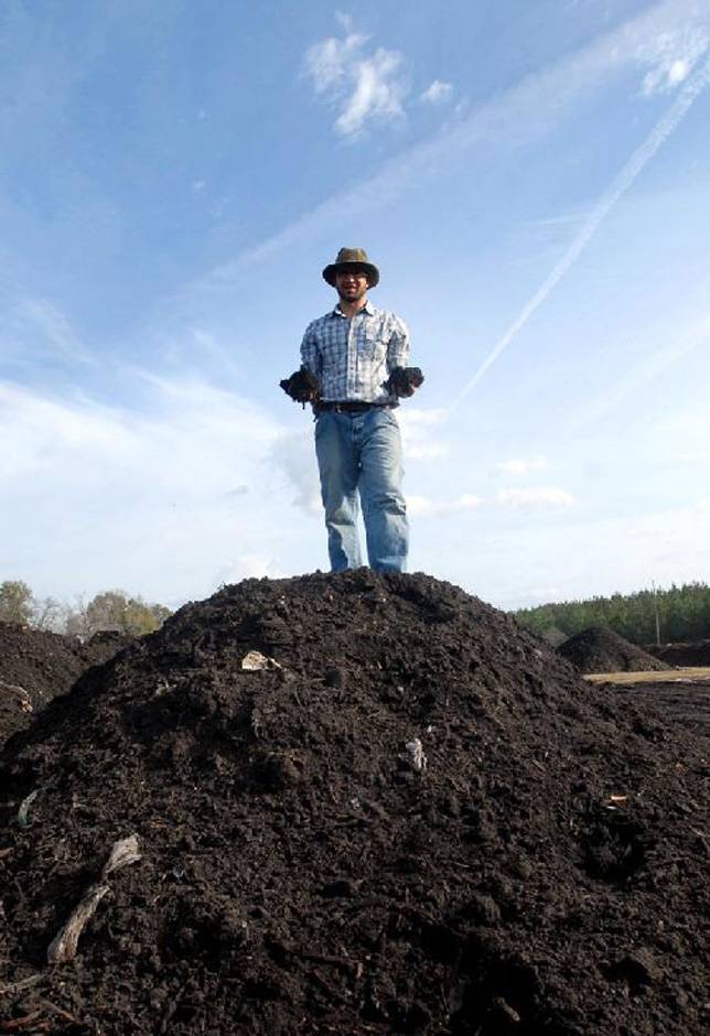 Daron Joffe on a pile of compost